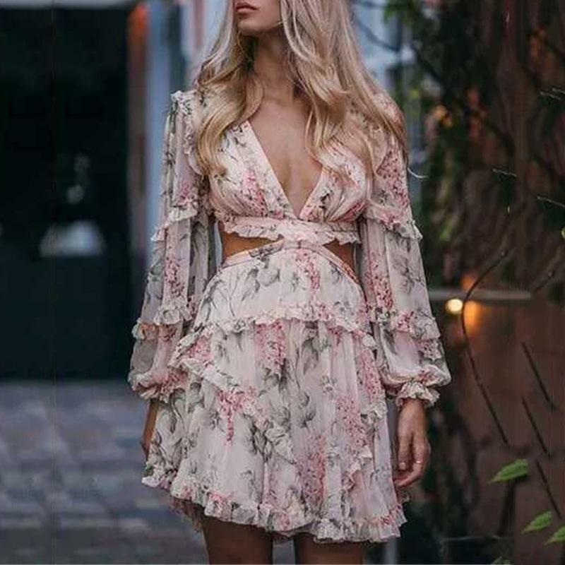 Deep V-neck back strap long sleeve mini print dress worn by model.