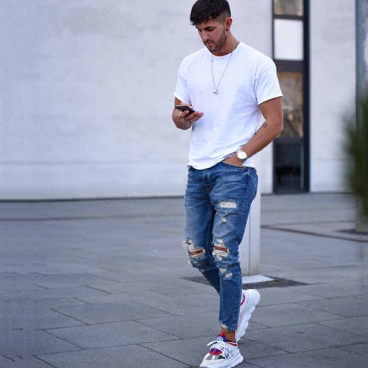 Men's jeans with holes, casual streetwear style.
