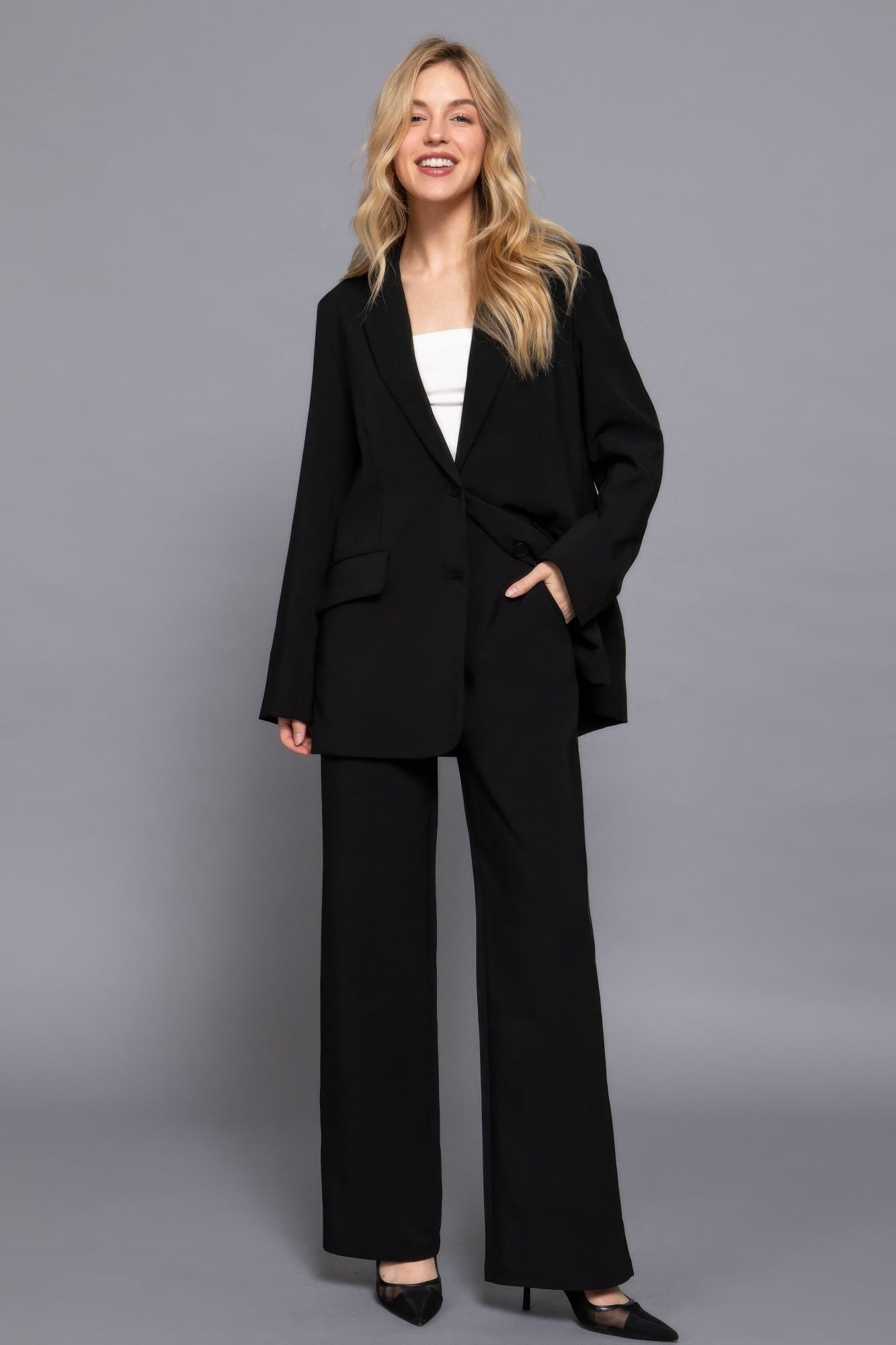 Back elastic straight woven long pants in black with straight-leg design and one-button detail.