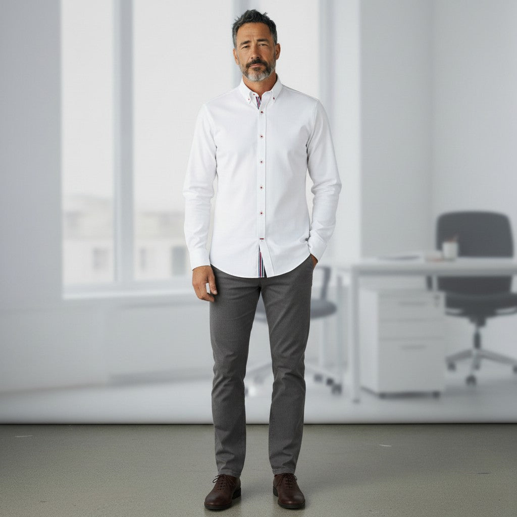 GIGI & POPO white long-sleeve button-down shirt with contrast trim on a professional man in a modern office setting.