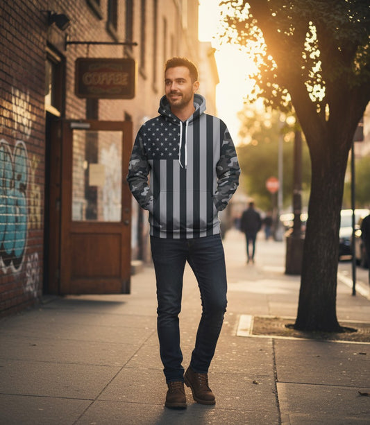 GIGI & POPO men's black and white American flag print hooded sweatshirt worn by a man on a sunny city sidewalk.