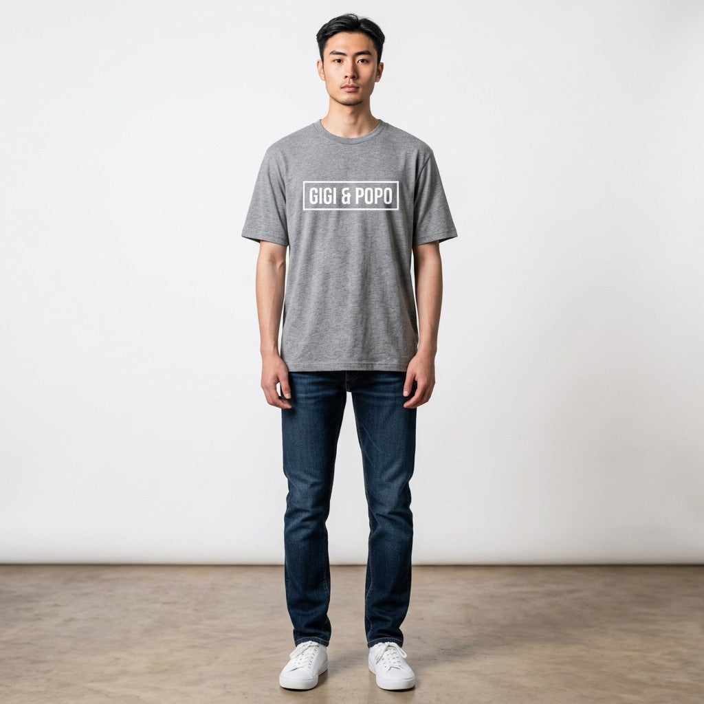 Model wearing a GIGI & POPO gray cotton crew neck t-shirt with white logo print, paired with dark blue jeans.