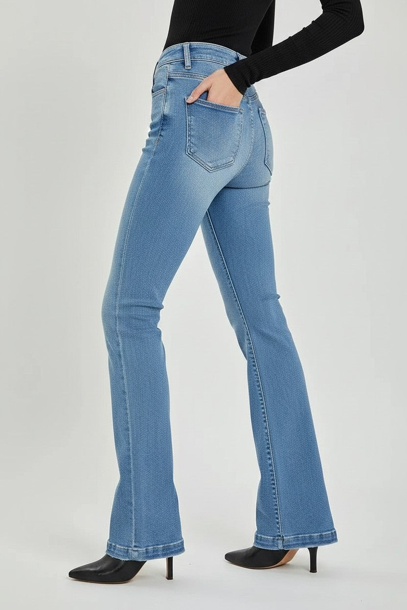 GIGI & POPO RISEN high rise bootcut jeans in medium wash denim with a button fly, shown from a side view.