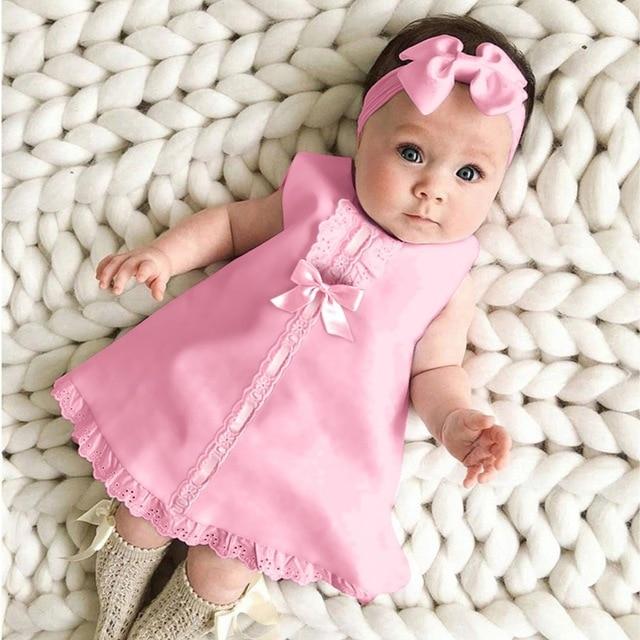 Lace hem sleeveless baby dress with headband, pink, casual A-line.